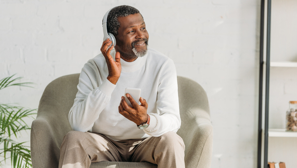 man with headphones sitting in chair
