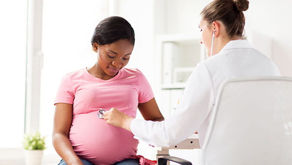 A pregnant woman with her care provider