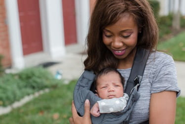 African American mother with baby in carrier