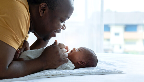 a man comforting a newborn child