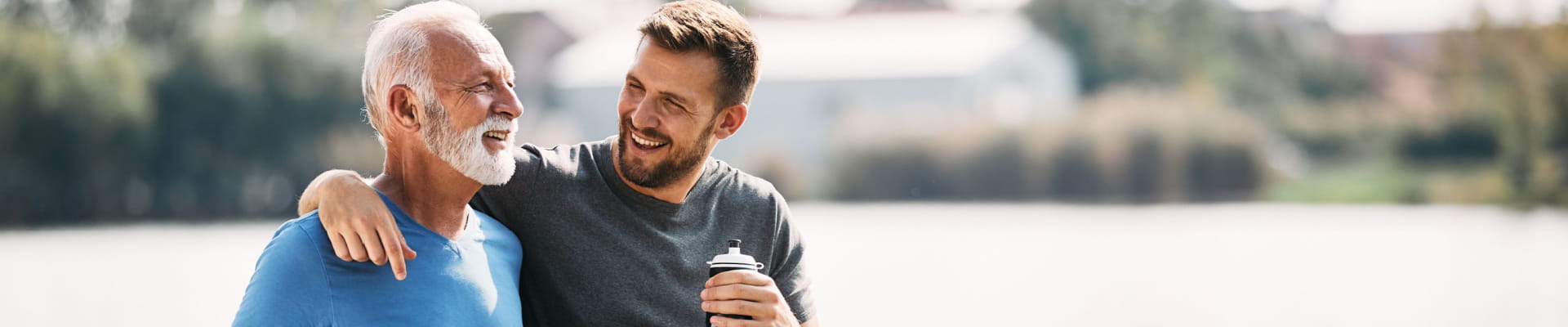 Two athletic and happy adult men walking outside.