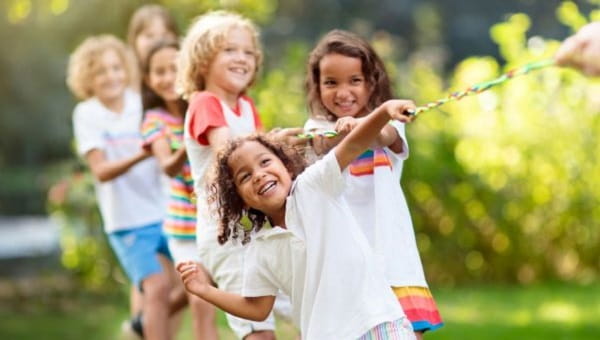 smiling children outside playing games together